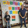 Austin Everett and Carl Birks in front of the poster 3rd
grader Austin drew and made for the day.